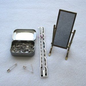 safety pins, seam gauge, mirror