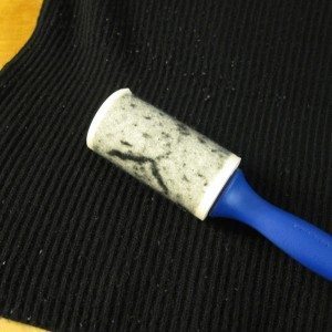 lint roller in use for sweater cleaning