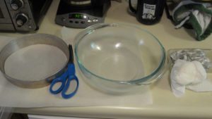 preparing the pans with parchment and grease