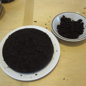 leveled chocolate cake with crumbs for siding