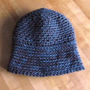 completed hat on table, moss stitch side out