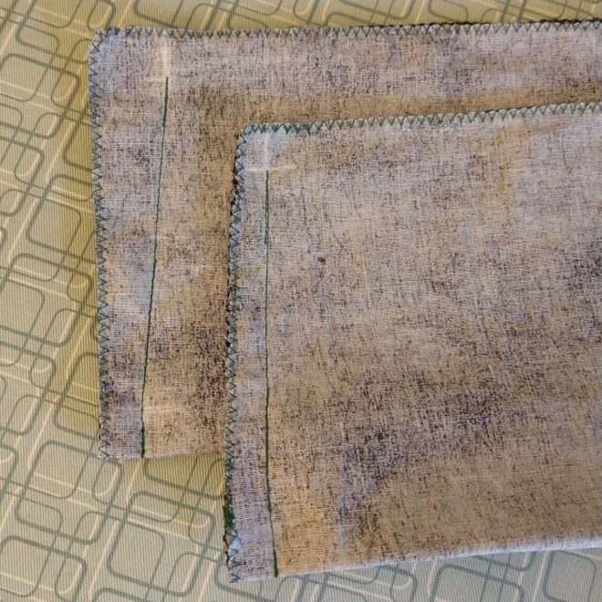 Pouches with side seam sewn, one untrimmed, one trimmed and re-zigzagged
